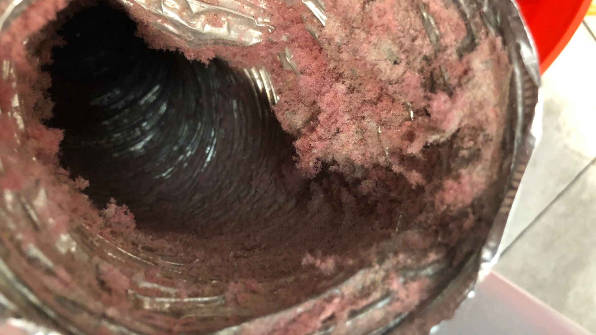 Mixing bowl with reddish-pink cake batter or brownie mix